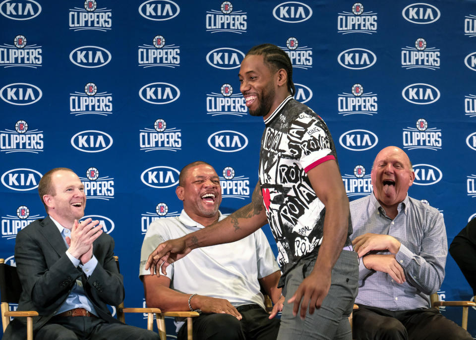 Los Angeles Clippers President of Basketball Operations Lawrence Frank, left, head coach Doc Rivers, second left, and team chairman Steve Ballmer, right, introduce Kawhi Leonard during a press conference in Los Angeles, Wednesday, July 24, 2019. Nearly three weeks after the native Southern California superstars shook up the NBA by teaming up with the Los Angeles Clippers, the dynamic duo makes its first public appearance. (AP Photo/Ringo H.W. Chiu)