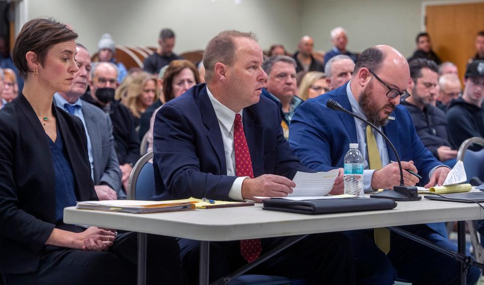 Then-Hopkinton police Sgt. Timothy Brennan, center, is shown with attorneys Elizabeth Keeley and Daniel Fogarty in January.