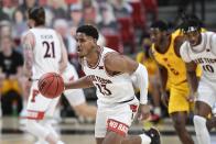 Texas Tech's Chibuzo Agbo (23) brings the ball up during the second half of the team's NCAA college basketball game against Iowa State in Lubbock, Texas, Thursday, March 4, 2021. (AP Photo/Justin Rex)