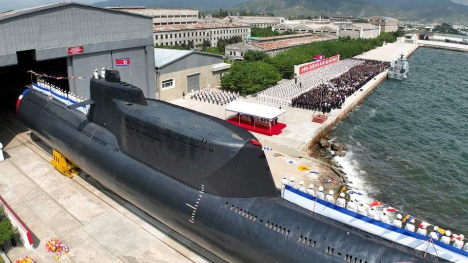 People attend what North Korean state media report was the country's launching ceremony for a new tactical nuclear attack submarine