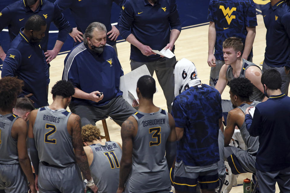 West Virginia coach Bob Huggins speaks with players during the second half of an NCAA college basketball game against Kansas State, Saturday, Feb. 27, 2021, in Morgantown, W.Va. (AP Photo/Kathleen Batten)