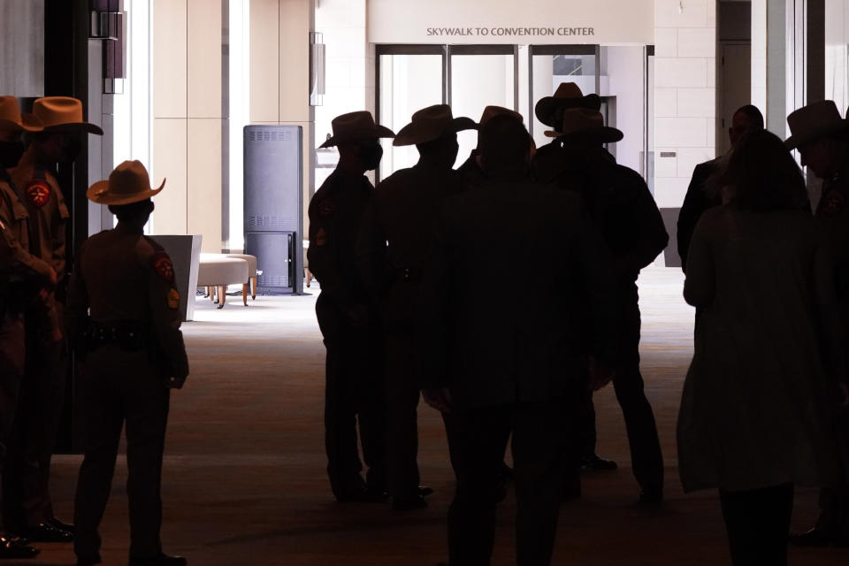 Texas DPS officers gather near a closed walkway to the Dallas convention center before a news conferenced about migrant children detentions Wednesday, March 17, 2021, in Dallas. (AP Photo/LM Otero)