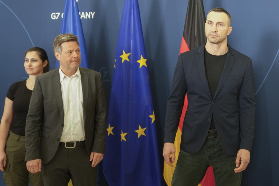 German Economy and Climate Minister Robert Habeck, center, welcomes former heavyweight boxing world champion Wladimir Klitschko, right, brother of Kyiv Mayor Vitali Klitschko, for talks in Berlin, Germany, Thursday, March 31, 2022. (AP Photo/Markus Schreiber)