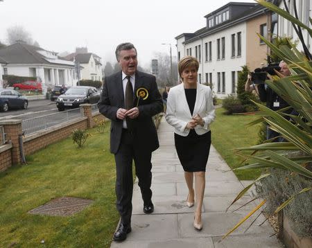 Scotland's First Minister Nicola Sturgeon and East Dunbartonshire SNP General Election candidate John Nicolson arrive at the Westerton Care Home for an election campaign visit in Glasgow, Scotland, April 6, 2015. REUTERS/Russell Cheyne