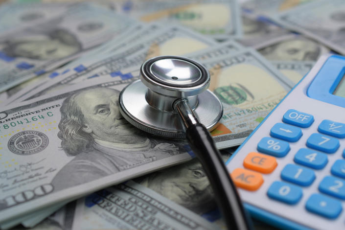 Healthcare payment concept with stethoscope and big money US dollar.