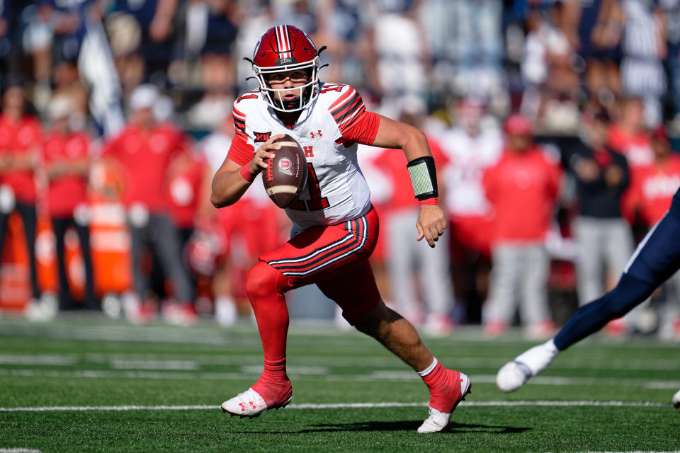 Sep 14, 2024; Logan, Utah, USA; Utah Utes quarterback Isaac Wilson (11) runs with the ball against the Utah State Aggies at Merlin Olsen Field in Maverik Stadium. Required credit: Jamie Sabau-Imagn Images