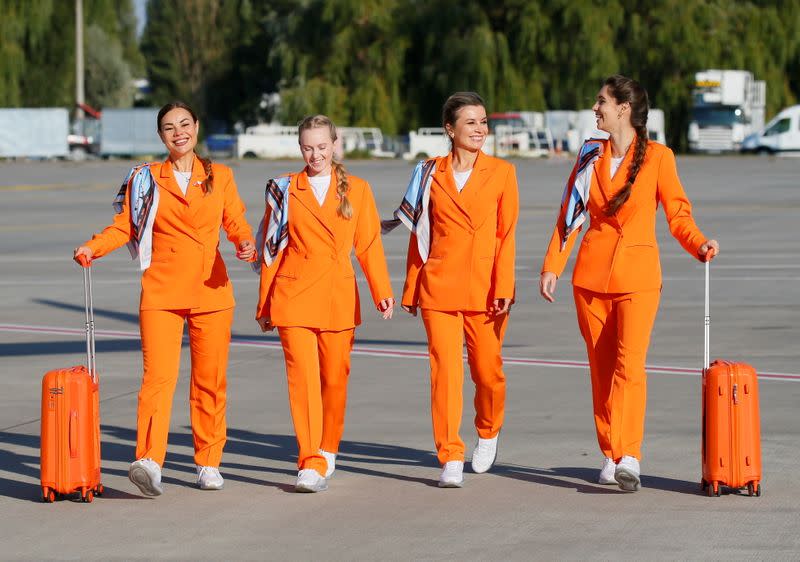 SkyUp Airlines flight attendants present a new uniform at an airport outside Kyiv