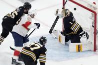 Florida Panthers' Carter Verhaeghe (23) scores on Boston Bruins' Jeremy Swayman (1) as Brandon Carlo (25) and Hampus Lindholm (27) defend during the second period in Game 3 of an NHL hockey Stanley Cup second-round playoff series Friday, May 10, 2024, in Boston. (AP Photo/Michael Dwyer)