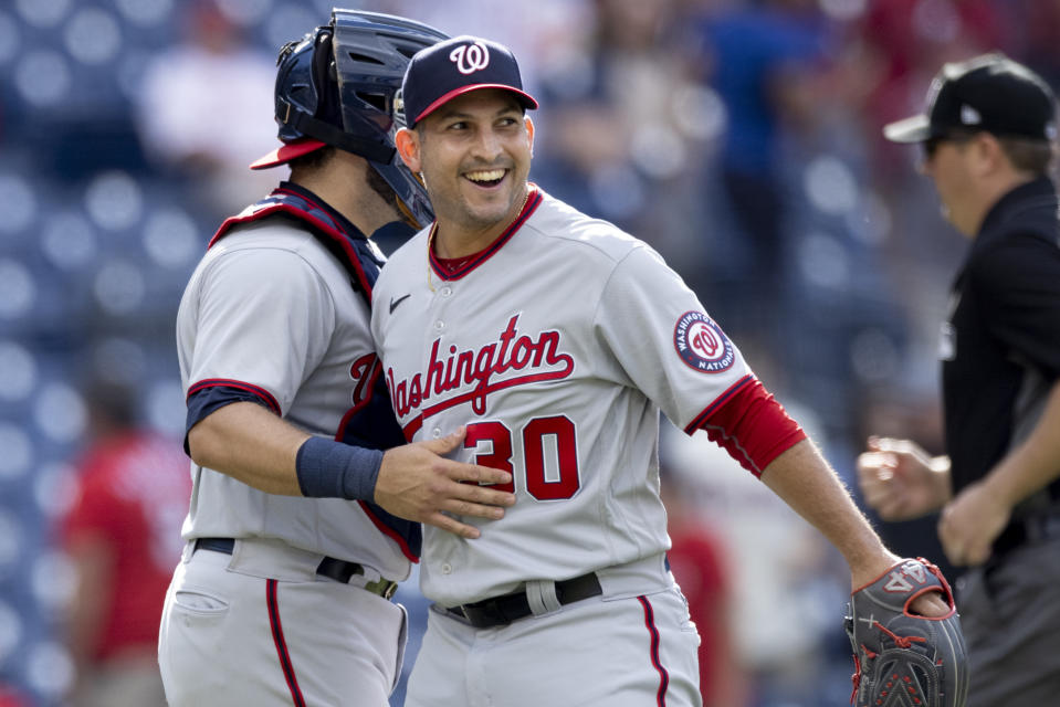 Washington Nationals closing pitcher Paolo Espino, right, celebrates with catcher Alex Avila, left, after the Nationals defeated the Philadelphia Phillies in a baseball game, Wednesday, June 23, 2021, in Philadelphia. (AP Photo/Laurence Kesterson)