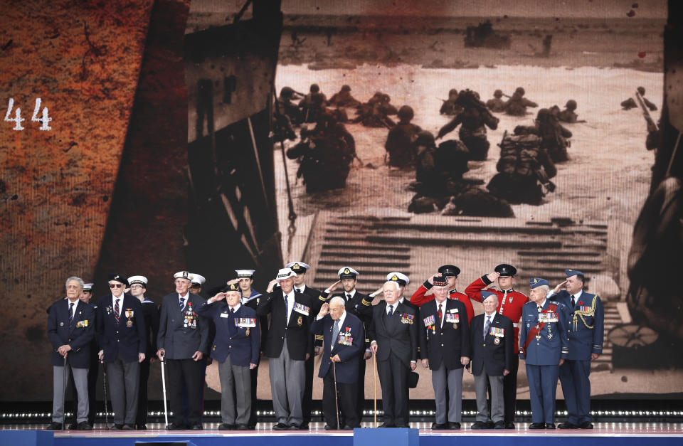 D-Day veterans, front row, stand on stage during an event to mark the 75th anniversary of D-Day in Portsmouth, England Wednesday, June 5, 2019. World leaders including U.S. President Donald Trump are gathering Wednesday on the south coast of England to mark the 75th anniversary of the D-Day landings. (AP Photo/Matt Dunham)