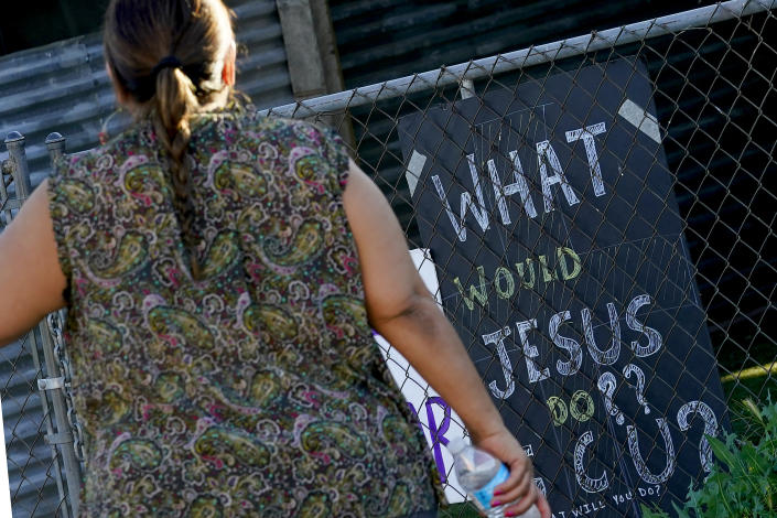 Alondra Ruiz Vazquez walks towards her home at the Periwinkle Mobile Home Park, Thursday, April 11, 2023, in Phoenix. Residents of the park are facing an eviction deadline of May 28 due to a private university's plan to redevelop the land for student housing. (AP Photo/Matt York)