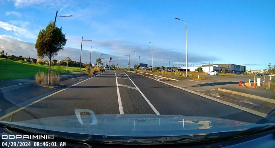 The dashcam footage captures the front of the car and the driver's view, with no parking signs in sight. 