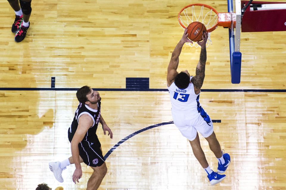 Creighton's Christian Bishop scores against Omaha's Matt Pile during the first half of an NCAA college basketball game in Omaha, Neb., Tuesday, Dec. 1, 2020. (AP Photo/Kayla Wolf)