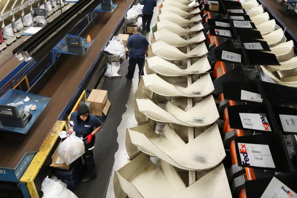 Employees sort packages inside FedEx’s superhub at the Memphis International Airport on Tuesday, November 20, 2018. 