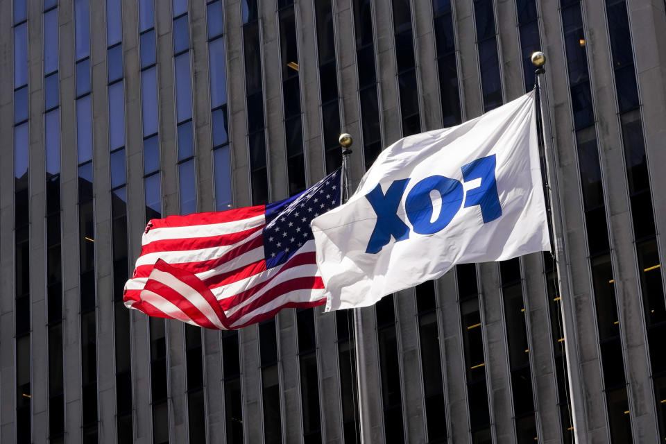 File - The American and Fox flags fly outside the News Corp. and Fox News headquarters on Wednesday, April 19, 2023, in New York. Fox Corp.'s hefty $787.5 million settlement with Dominion over defamation charges is unlikely to make a dent in Fox's operations, analysts say. (AP Photo/Mary Altaffer, File)