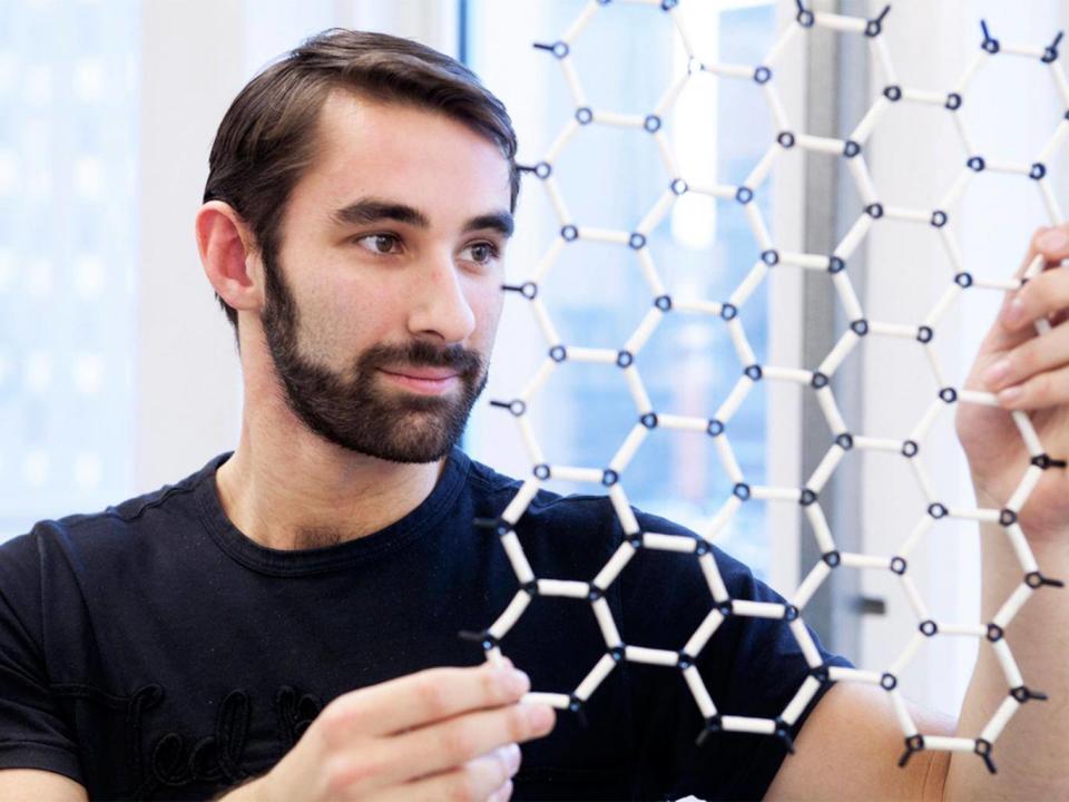 A scientist inspects a model of graphene’s super-fine structure; it can ‘separate items smaller than an atom’ (Graeme Cooper)