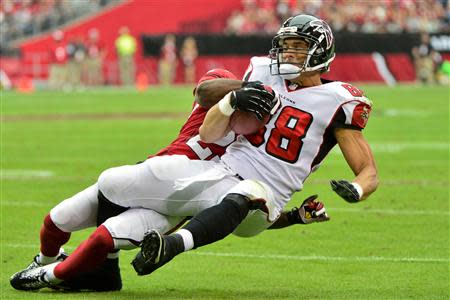 Atlanta Falcons tight end Tony Gonzalez (88) is tackled by Arizona Cardinals cornerback Jerraud Powers (25) during the first half at University of Phoenix Stadium. Mandatory Credit: Matt Kartozian-USA TODAY Sports