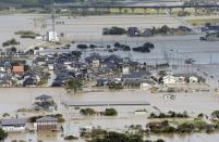 An aerial view shows residential areas flooded by the Yura river after tropical storm Man-yi, also known locally as Typhoon No.18, hit in Fukuchiyama, Kyoto prefecture, in this photo taken by Kyodo September 16, 2013. Torrential rain hit western Japan on Monday morning as the Man-yi made landfall in the country's central region, prompting the weather agency to warn of "unprecedented heavy rain" and urge people to take safety precautions. In Kyoto Prefecture, some 260,000 residents were ordered to evacuate, including about 81,000 in Fukuchiyama, Kyodo news reported. Mandatory Credit. REUTERS/Kyodo