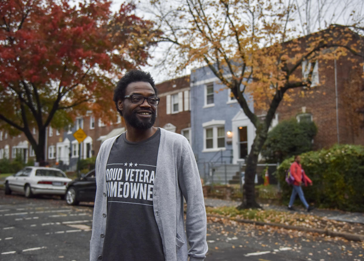 Marrio Pearson, who served in the U.S. Army from 1990 to 1999, looks out into his new neighborhood in front of his southeast DC rowhouse in Washington, DC. Pearson, received a mortgage through the Veteran Home Loan program.  (Credit: Jahi Chikwendiu, The Washington Post via Getty Images)