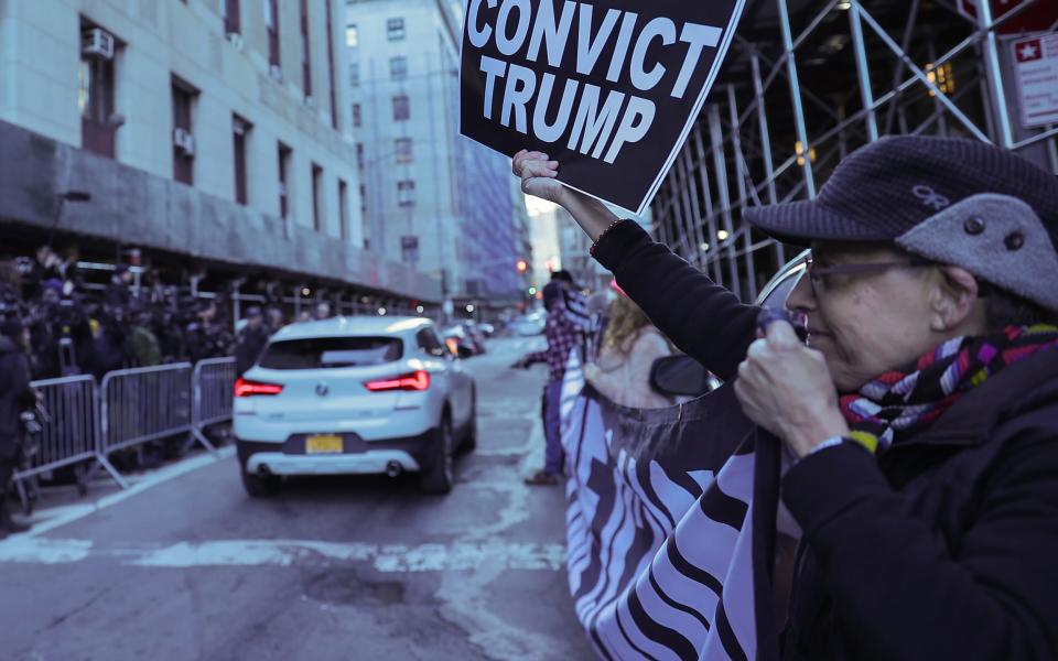 Demonstrators carry a banner outside Manhattan District Attorney Alvin Bragg's Office - Selcuk Acar/Anadolu Agency via Getty Images