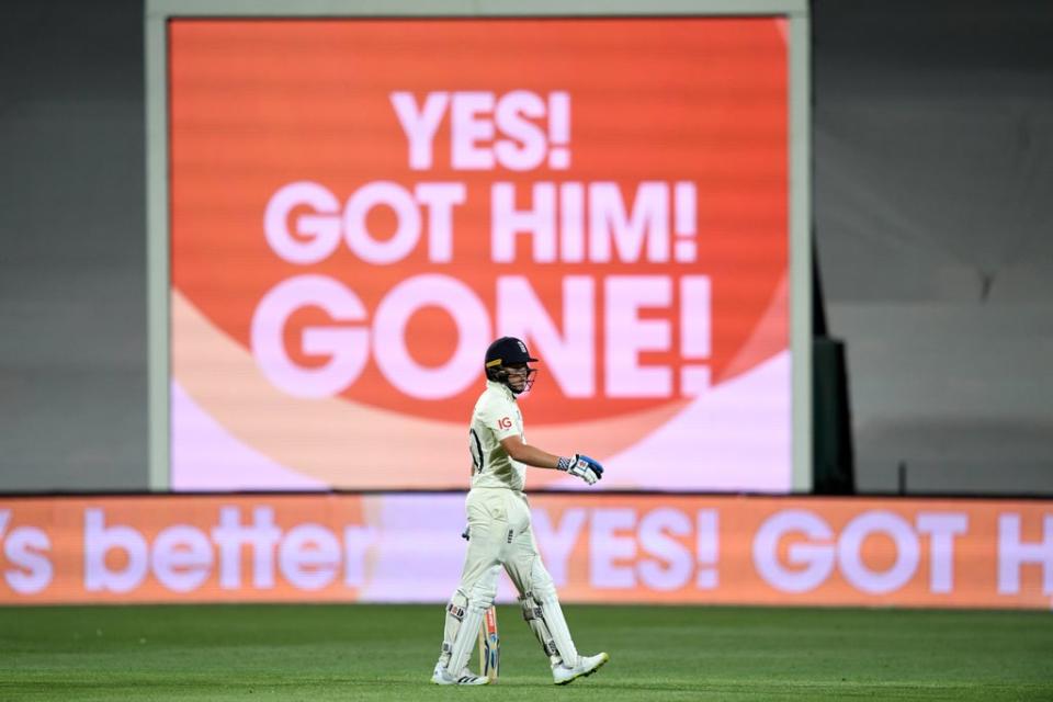 Ollie Pope walks off the field after being clean bowled (PA)