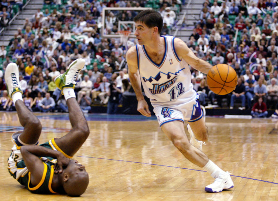 Seattle SuperSonics guard Gary Payton, left, falls back while gasping for air after Utah Jazz guard John Stockton, right, elbowed him in the throat before driving toward the basket during the second half Thursday, Jan. 16, 2003, in Salt Lake City. (AP Photo/Steve C. Wilson)