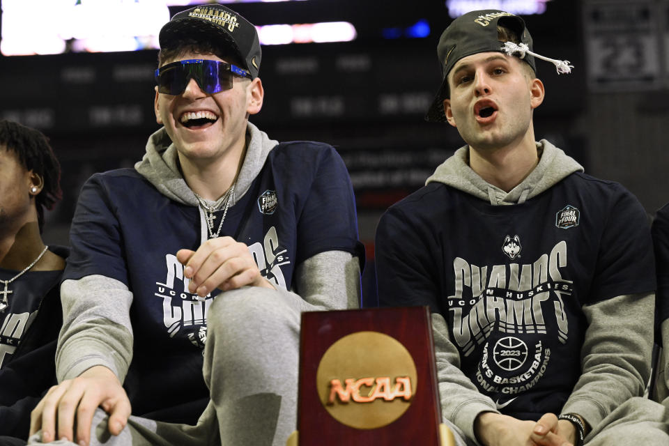 UConn's Donovan Clingan, left, and Joey Calcaterra, right, react during a rally at Gampel Pavilion in honor of the team's NCAA men's Division I basketball championship, Tuesday, April 4, 2023, in Storrs, Conn. (AP Photo/Jessica Hill)