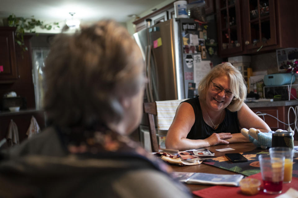 Susan Ryder, right, smiles at her mother, Betty Bednarowski, during breakfast, Wednesday, Dec. 1, 2021, in Rotterdam Junction, N.Y. (AP Photo/Wong Maye-E)