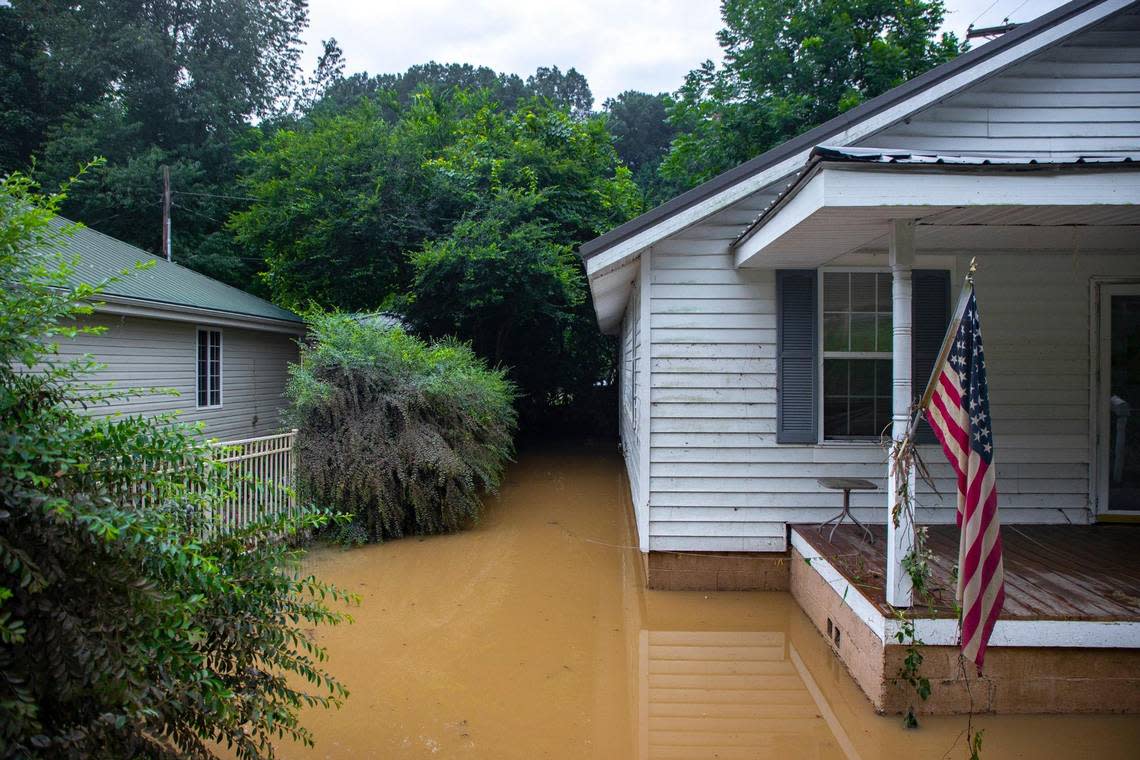 Receding flood waters surround a home in Whitesburg, Ky., on Friday, July 29, 2022.