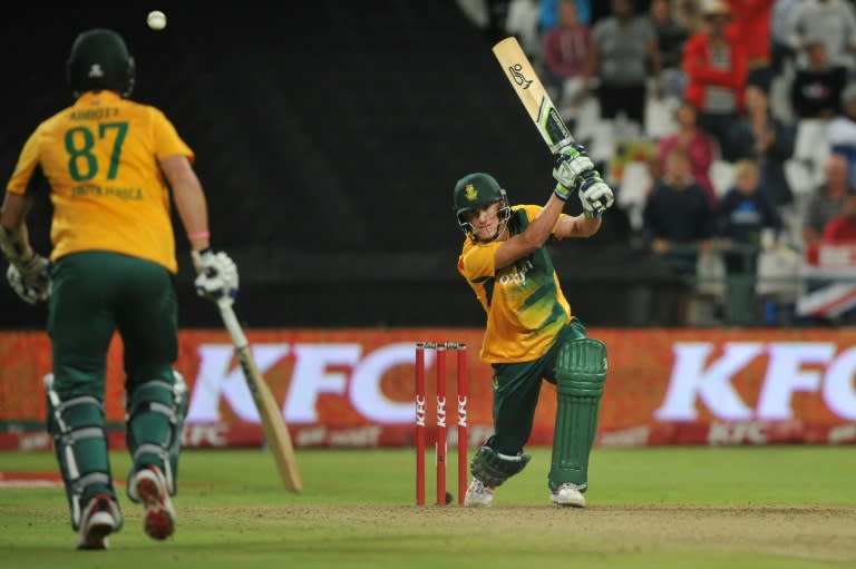 South African batsman Chris Morris (R) plays a shot during the first of two T20 matches being played against England, at Newlands on February 19, 2016, in Cape Town