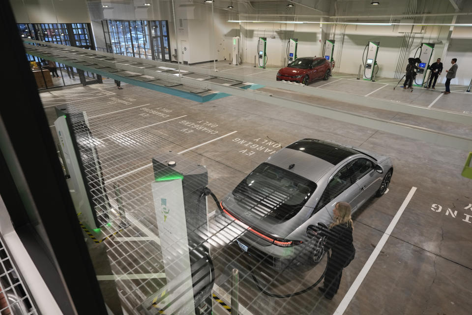 A car gets charged at the new Electrify America indoor electric vehicle charging station during a preview in San Francisco, Wednesday, Feb. 7, 2024. Electrify America, Tesla, Mercedes and other charging networks are starting to build nicer spots for people to fill up their electric vehicles, knowing they'll be there for a lot longer than people spend at gas stations. (AP Photo/Eric Risberg)