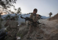 FILE - In this Sept. 12, 2011, file photo, Pfc. Bryan Corteal, 22, of Bullhead City, Ariz., with the U.S. Army's 25th Infantry Division, 3rd Brigade Combat Team, 2nd Battalion 27th Infantry Regiment based in Schofield Barracks, Hawaii, hikes up to begin an overwatch shift on a hilltop observation post at Combat Outpost Monti in Kunar province, Afghanistan. President Joe Biden and his NATO counterparts bid a symbolic farewell to Afghanistan on Monday, June 14, in their last summit before America winds up its longest “forever war” and the military pulls out for good. (AP Photo/David Goldman, File)