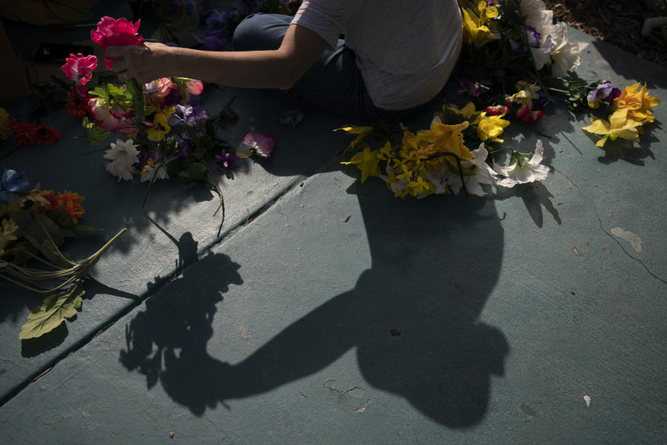 Trina Ansdell, wife of Allan Ansdell Jr, owner and president of Adventure City amusement park, sorts artificial flowers for decoration ahead of the park's reopening in Anaheim, Calif., Thursday, April 15, 2021. The family-run amusement park that had been shut since March last year because of the coronavirus pandemic reopened on April 16. "It has been an emotional roller coaster, especially watching my husband and the family," said the wife. "It was hard to get excited at the beginning that we finally had the green light or that it was soon in the distance because we've been on hold for so long." (AP Photo/Jae C. Hong)