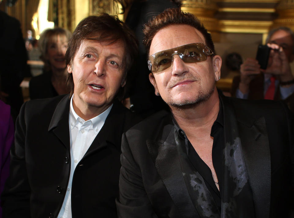 Sir Paul McCartney and Bono pose for photographers prior to fashion designer Stella McCartney's Fall/Winter 2013-2014 ready to wear collection, in Paris, Monday, March, 4, 2013. (AP Photo/Thibault Camus)