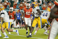 Pittsburgh running back Israel Abanikanda (2) runs past Miami linebacker Caleb Johnson (40) for a touchdown during the first half of an NCAA college football game, Saturday, Nov. 26, 2022, in Miami Gardens, Fla. (AP Photo/Lynne Sladky)