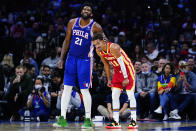 Philadelphia 76ers' Joel Embiid, left, embraces Atlanta Hawks' Trae Young during the first half of an NBA basketball game, Saturday, Oct. 30, 2021, in Philadelphia. (AP Photo/Matt Slocum)