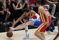Atlanta Hawks' Trae Young (11) and Milwaukee Bucks' Pat Connaughton (24) both dive for the ball during the second half of Game 3 of the NBA Eastern Conference basketball finals, Sunday, June 27, 2021, in Atlanta. (AP Photo/Brynn Anderson)