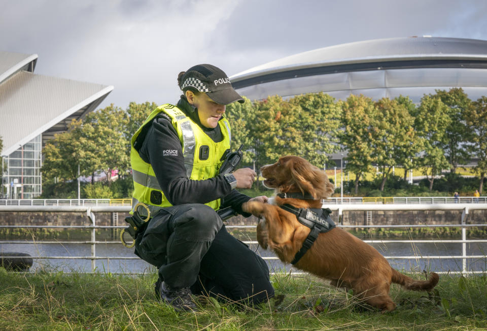 <p>Dog handler Lynsey Buchanan-Barlas with specialist search dog Nico alongside the River Clyde near the COP26 venues as Police Scotland counter terrorism announce a Project Servator campaign ahead of the international climate conference, being held in Glasgow. Project Servator aims to to deter, detect and disrupt a range of criminal activity, including terrorism. Picture date: Monday October 4, 2021.</p>

