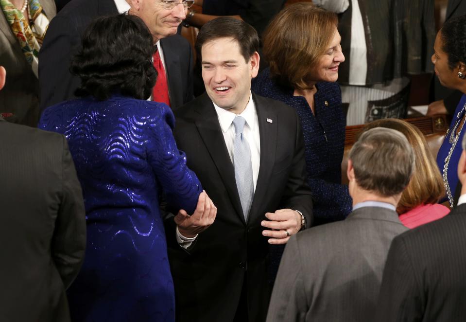U.S. Senator Rubio is greeted by colleagues as he arrives to listen to U.S. President Obama deliver his State of the Union address to a joint session of the U.S. Congress on Capitol Hill in Washington