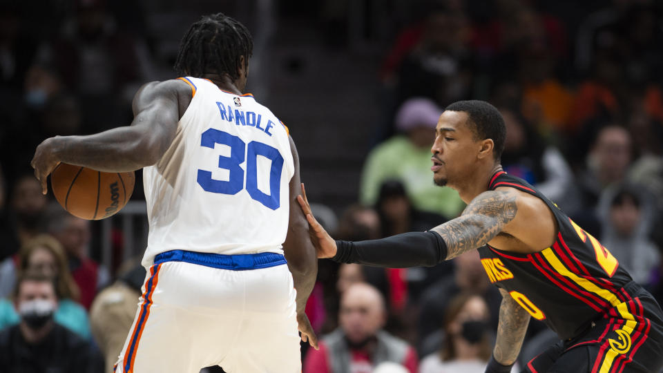 Atlanta Hawks forward John Collins (20) defends New York Knicks forward Julius Randle (30) during the first half of an NBA basketball game Saturday, Nov. 27, 2021, in Atlanta. (AP Photo/Hakim Wright Sr.)