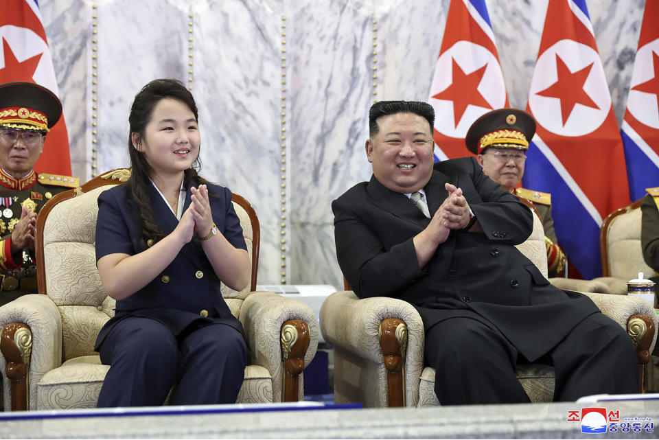 In this photo provided Saturday, Sept. 9, 2023, by the North Korean government, North Korea leader Kim Jong Un, right, with his daughter, left, watches a paramilitary parade marking North Korea’s 75th founding anniversary in Pyongyang, North Korea, Friday, Sept. 8. Independent journalists were not given access to cover the event depicted in this image distributed by the North Korean government. The content of this image is as provided and cannot be independently verified. Korean language watermark on image as provided by source reads: "KCNA" which is the abbreviation for Korean Central News Agency. (Korean Central News Agency/Korea News Service via AP)