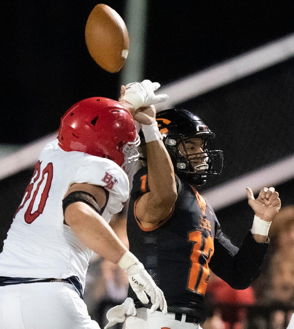 Brentwood Academy's Hank Weber (60) breaks up a pass as Ensworth's Levi Moore (12) tries to throw late in the fourth quarter at Ensworth High School Thursday, Oct. 20, 2022, in Nashville, Tenn. 