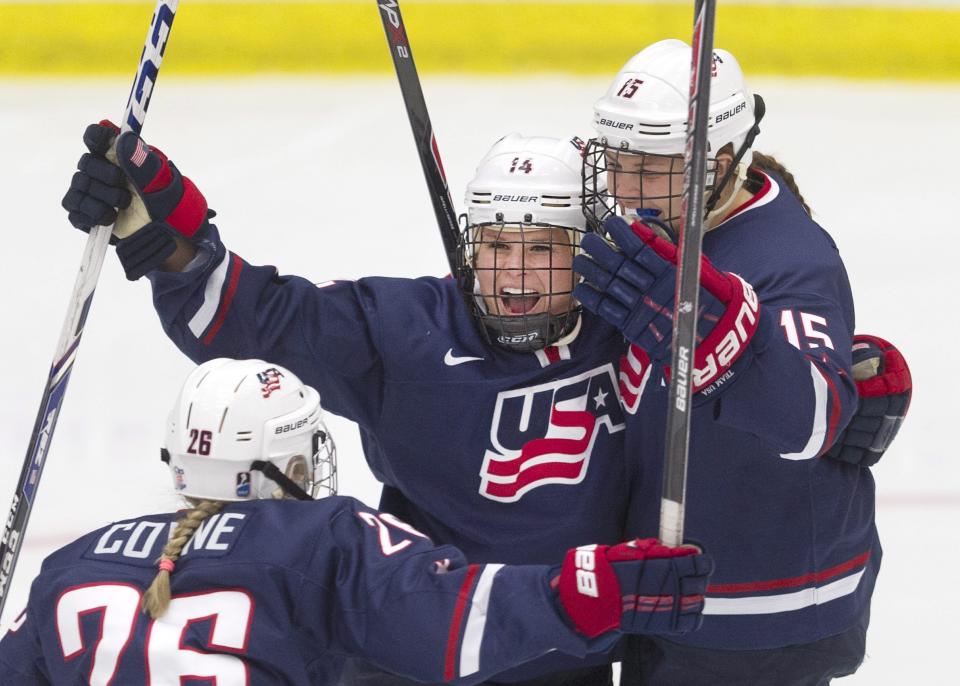 FILE - United States's Brianna Decker, center, celebrates her goal against Canada with teammates Kendall Coyne, left, and Anne Schleper during a pre-Olympic women's hockey game in Calgary, Alberta, Thursday, Dec. 12, 2013. Olympic gold medalist and six-time world champion Brianna Decker announced her retirement from the U.S. Women’s National Team, Thursday, March 2, 2023. (Larry MacDougal/The Canadian Press via AP, File)