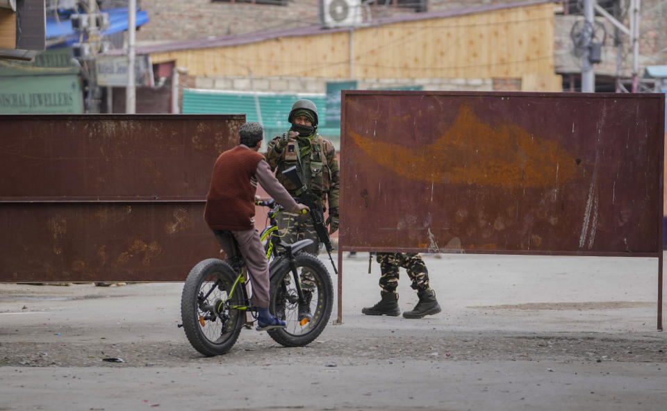 A paramilitary soldier stops a man on a bicycle near at a closed road near a venue where Indian Prime Minister Narendra Modi is scheduled to address a public rally Srinagar, Indian controlled Kashmir, Thursday, March 7, 2024. Modi on Thursday is making his first official visit to Kashmir’s main city since New Delhi stripped the disputed region’s semi-autonomy and took direct control of it in 2019. (AP Photo/Mukhtar Khan)