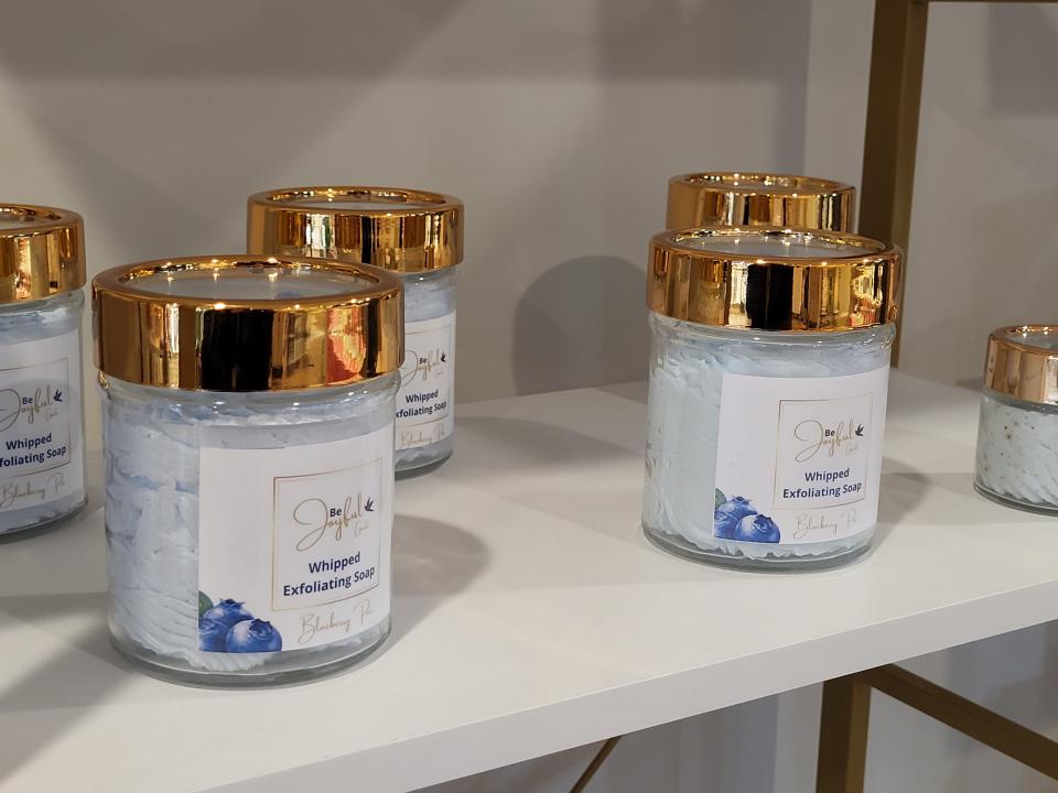 Jars of blueberry whipped exfoliating soap await customers on the shelves of Massage 325 on Monday, Dec. 19, 2022.