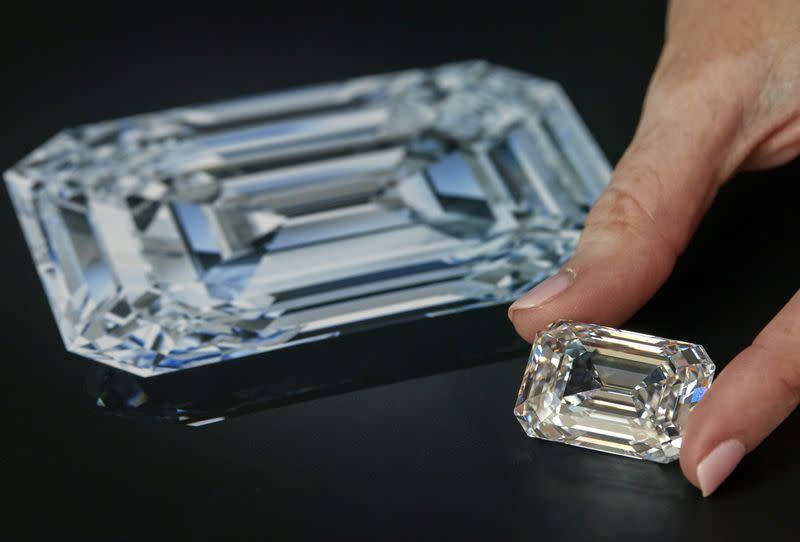 A staff holds a rectangular step-cut diamond of 100.94 carats during a preview at Christie's in Geneva