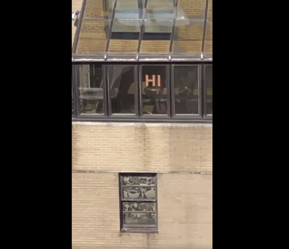 Two New York City neighbors communicated by posting messages on the windows of their respective buildings and formed a beautiful friendship in the process. (Screenshot: Courtesy of Lilian Kogan)