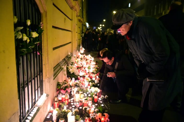 Mourners leave flowers and candles at a memorial in Budapest on January 22, 2017 for the victims of Friday's deadly coach crash in Italy