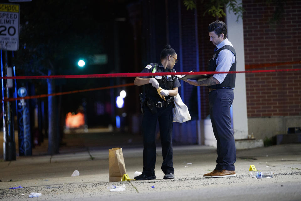 Chicago police officers work at the scene where at least eight people were wounded in a shooting involving a party bus in the 1600 block of North LaSalle Drive in the Old Town Triangle neighborhood Thursday July 22, 2021 in Chicago.(Armando L. Sanchez /Chicago Tribune via AP)