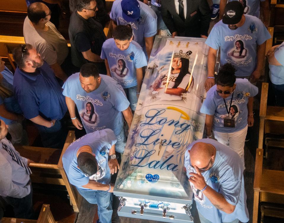 The casket of 15-year-old Alycia "Lala" Reynaga is escorted out of the Cathedral of the Annunciation after funeral services in Stockton on May 4. Reynaga, a Stagg High School student, was stabbed and killed by a school intruder on April 19.
